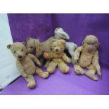 Five mid 20th century soft toys, a Merrythought Monkey and dog and similar lamb and teddy bears