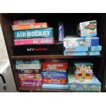 Two shelves of modern games and puzzles including Rapidough, Eggheads, Logo etc