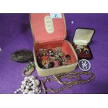 A small selection of costume jewellery including cufflinks, brooches, beads etc