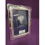 A silver plated photograph frame having moulded decoration