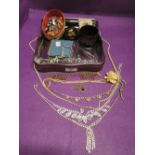 A selection of costume jewellery including diamante, brooches, papier mache trinket, compact etc