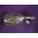 An Edwardian silver dressing table brush having cherubic decoration, Chester 1901, William Neale