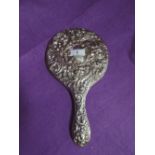 An HM silver dressing table hand mirror having moulded mask and bird decoration