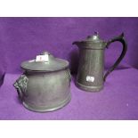 A vintage pewter biscuit barrel with lion head handles and similar coffee pot