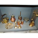 A selection of vintage brass and copper fire side items including graduated measuring cup set