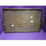 An arts and crafts style butlers tray with carved detailing dated 1924