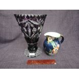 A Bohemian cut flash glass in purple and a Crown Devon lustre ribbed jug having floral decoration