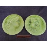 A pair of Burmantofts faience plaques modelled as ladies in profile, signed P Mallet 1886 and