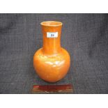 An early 20th century Ruskin vase of bulbous bottle form having orange mottled decoration, stamped