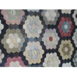 A selection of 19th century patchwork, fabric fragments of hexagonal rosette design in later frame