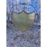 A Victorian Arts and Crafts wrought iron, copper and amber glass fire screen