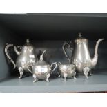 a vintage metal tea set with footed design