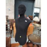 A male torso mannequin on stand