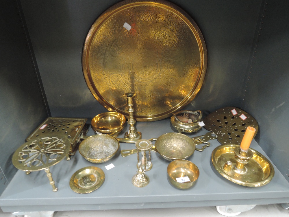 A selection of vintage brass wares including chamber stick, roasters, and Indian