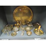 A selection of vintage brass wares including chamber stick, roasters, and Indian