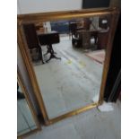 A gilt frame wall mirror