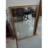 A gilt frame wall mirror