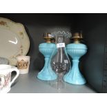 Two vintage blue glass well oil burner lamps