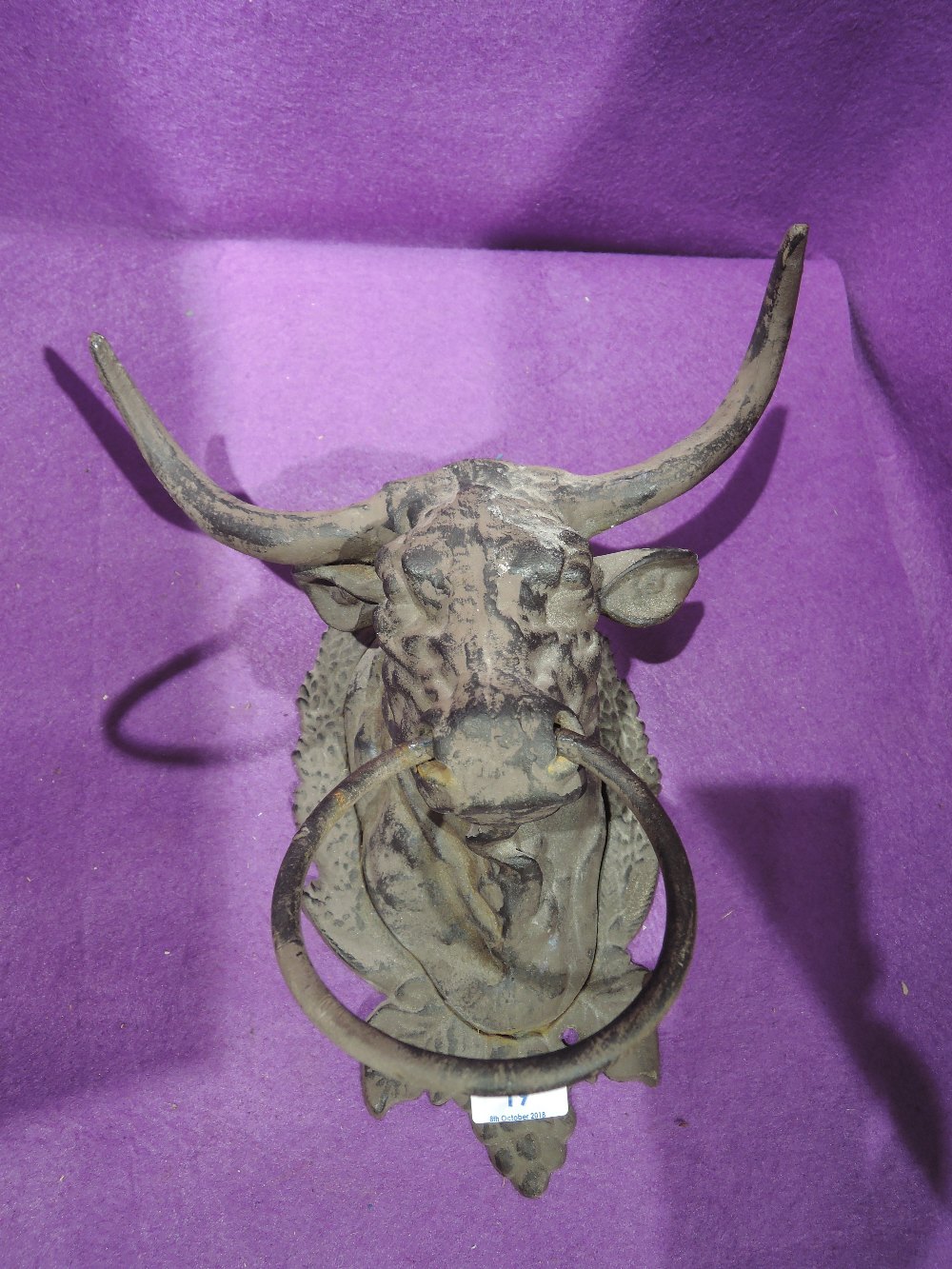 A vintage metal cast bulls head towel holder