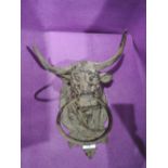 A vintage metal cast bulls head towel holder