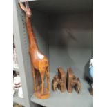 a pair of vintage hard wood elephant book ends and similar giraffe figure