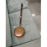 A traditional copper warming pan, of small proportions