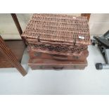 Two vintage suitcases and a wicker hamper