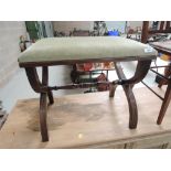 A vintage savanarola type stool having green dralon seat