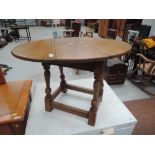 A mid 20th Century golden oak drop leaf occasional table