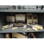 A selection of vintage cutlery flatware and canteen with bone effect handles