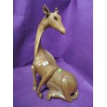 A vintage hand carved African style wooden giraffe figure