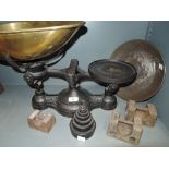 A large cast scale and balance set with graduated weights