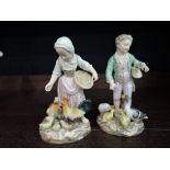A pair of Meissen style figure groups, Children feeding ducks and hens (af)