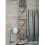 A set of vintage wooden ladders and ladder stay