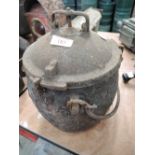A vintage cast iron pressure cooker