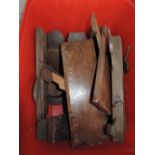 A box of various wooden block planes, side planes and moulding planes