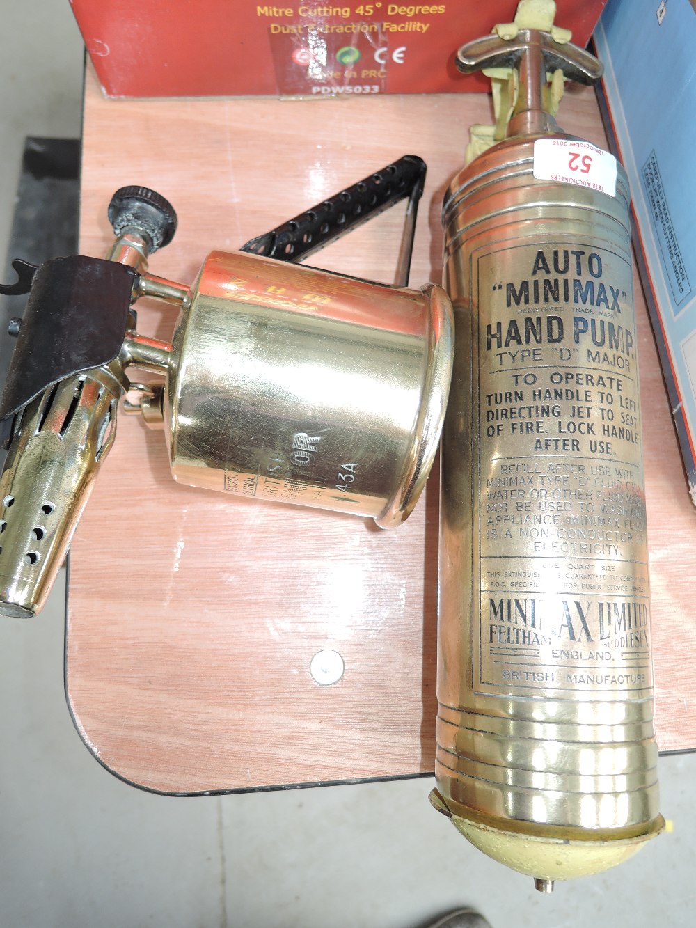 A vintage brass Minimax fire extinguisher and Monitor blow torch