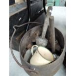 A cast iron pan and contents including enamel mug etc