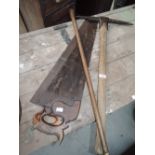 A selection of vintage tools and cane including pick axe