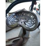 A vintage farm implement or tractor seat