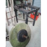 A vintage grinding stone large size with heavy cast base
