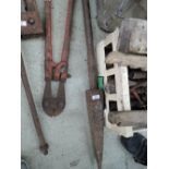 A large cast iron poker and bolt cutters