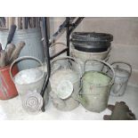 A selection of vintage galvanised watering cans and buckets