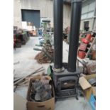 A modern cast wood burning stove with chimney