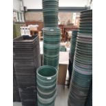 Three stacks of large polypropylene plant pots