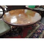 An early Victorian loo/dining table having oval flip top on bulbous pedestal and quadrafoil splay