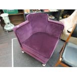 An Art Deco design corner armchair with later purple dralon upholstery