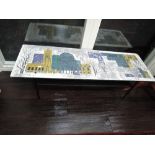 A coffee table by John Piper having stylised laminate top showing London landmarks, on black frame