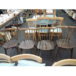 A set of 4 dark stained Ercol style spindle back kitchen chairs