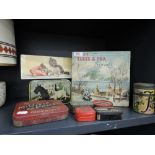 A selection of vintage advertising tins including Elkes And Fox, and dog and cat prints
